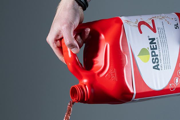 Pouring red petrol from a red plastic can